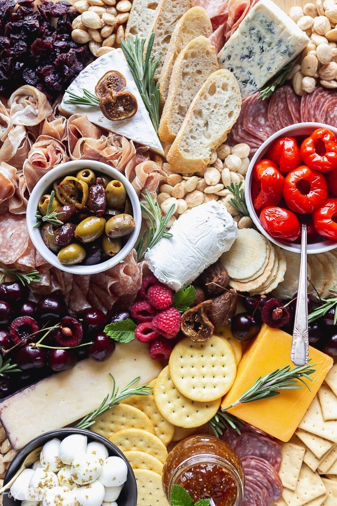 No party is complete without an epic charcuterie board.  Follow these step by step photos to learn how to make a charcuterie board. | how to make a cheese board | party appetizer | holiday appetizer | cheese and wine | Charcuterie ideas | Cheeseboard ideas | cheese board for holidays | summer cheese board | Fall Cheeseboard | Party platter #ad @qfc