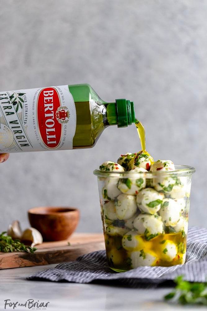 These Olive Oil Marinated Mozzarella Balls are a quick and easy appetizer that takes less than 15 minutes to make. @bertolli #ad #TheRecipeIsSimple | Make Ahead | For a party | Quick | For a crowd | cold appetizer | no cook | bites | finger food | snacks | Low carb appetizers