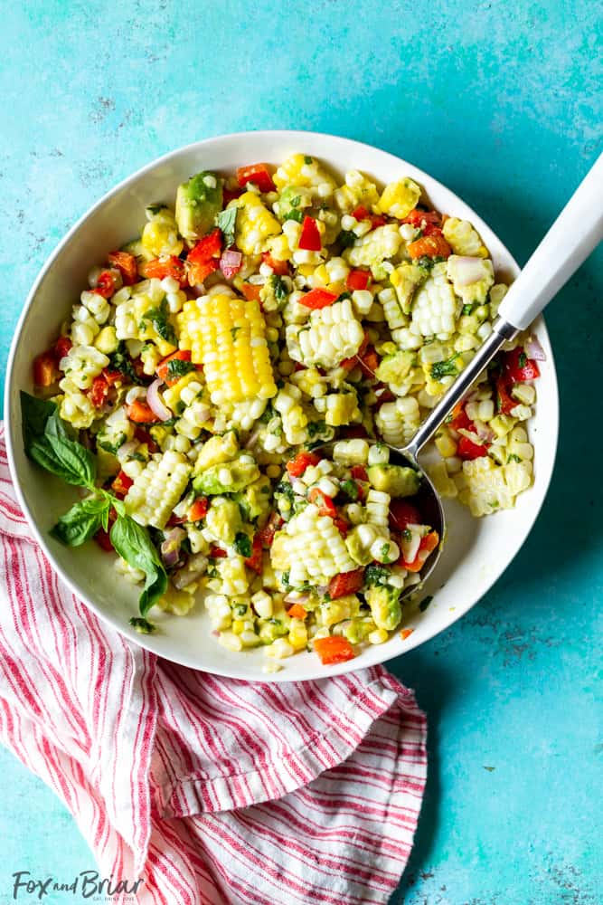 This Fresh Summer Corn Salad is the best side dish to bring to a BBQ, cookout or picnic!  It uses fresh summer produce and can be made ahead of time. | Easy Corn Salad Recipe | BBQ Side Dish | Potluck | cookout | labor day | Fourth of July | Memorial day | Barbque side | Cold food | Make ahead | food to bring to a party