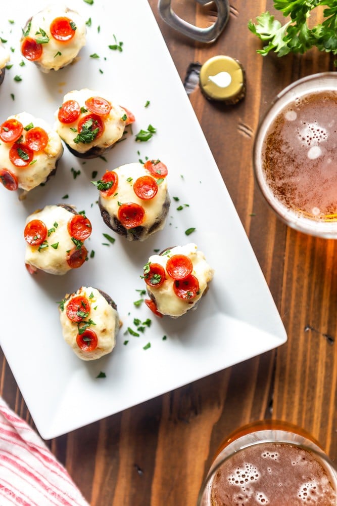 These Pizza Dip Stuffed Mushrooms are bite sized appetizers, perfect for game day.  These low carb, easy stuffed mushrooms have big pizza flavor. Easy stuffed mushrooms | Low Carb Stuffed Mushrooms | Keto Stuffed Mushrooms | Football Party Food | Tailgaiting food | Stuffed mushroom appetizers | Gluten free stuffed mushrooms | for kids | for families | superbowl party food | Thanksgiving appetizer | Christmas appetizer