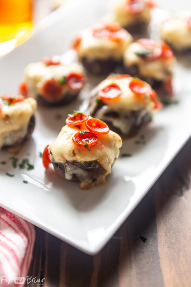 These Pizza Dip Stuffed Mushrooms are bite sized appetizers, perfect for game day.  These low carb, easy stuffed mushrooms have big pizza flavor. Easy stuffed mushrooms | Low Carb Stuffed Mushrooms | Keto Stuffed Mushrooms | Football Party Food | Tailgaiting food | Stuffed mushroom appetizers | Gluten free stuffed mushrooms | for kids | for families | superbowl party food | Thanksgiving appetizer | Christmas appetizer