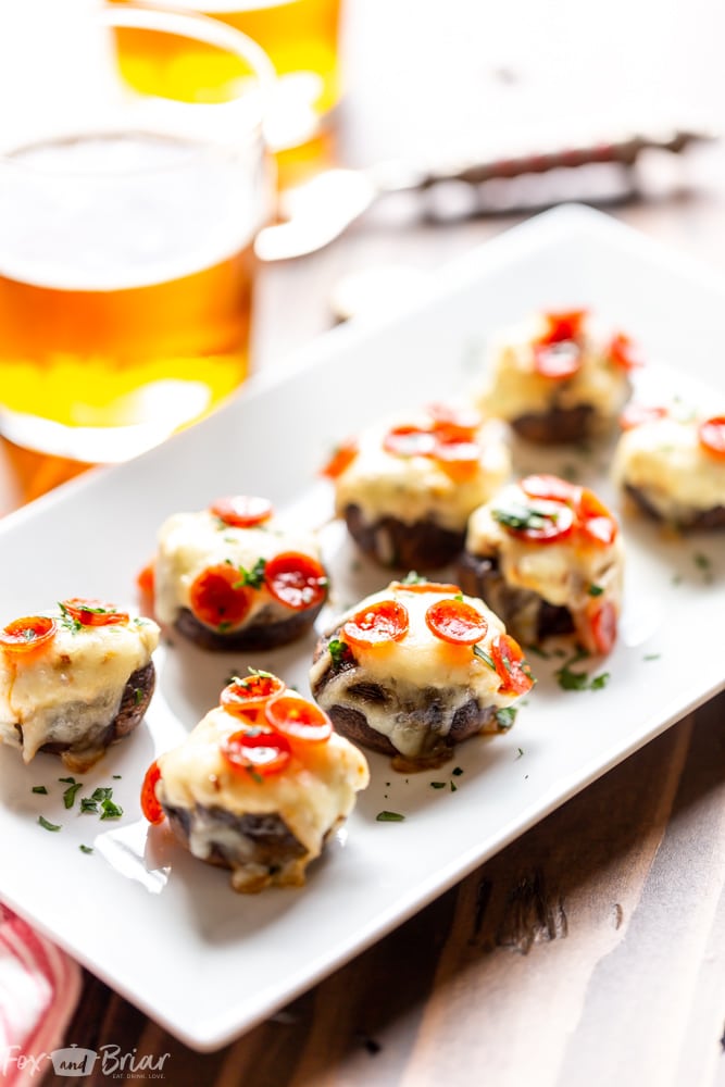 These Pizza Dip Stuffed Mushrooms are bite sized appetizers, perfect for game day.  These low carb, easy stuffed mushrooms have big pizza flavor. Easy stuffed mushrooms | Low Carb Stuffed Mushrooms | Keto Stuffed Mushrooms | Football Party Food | Tailgaiting food | Stuffed mushroom appetizers | Gluten free stuffed mushrooms | for kids | for families | superbowl party food | Thanksgiving appetizer | Christmas appetizer