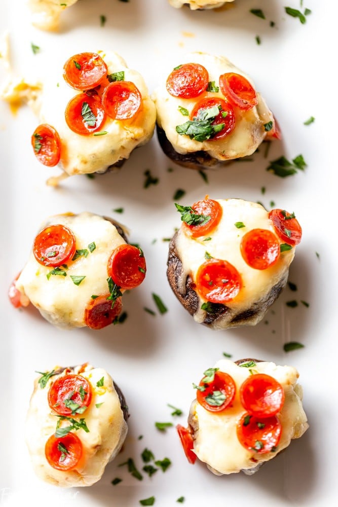 These Pizza Dip Stuffed Mushrooms are bite sized appetizers, perfect for game day.  These low carb, easy stuffed mushrooms have big pizza flavor. Easy stuffed mushrooms | Low Carb Stuffed Mushrooms | Keto Stuffed Mushrooms | Football Party Food | Tailgaiting food | Stuffed mushroom appetizers | Gluten free stuffed mushrooms | for kids | for families | superbowl party food | Thanksgiving appetizer | Christmas appetizer