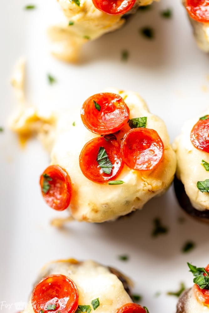 These Pizza Dip Stuffed Mushrooms are bite sized appetizers, perfect for game day.  These low carb, easy stuffed mushrooms have big pizza flavor. Easy stuffed mushrooms | Low Carb Stuffed Mushrooms | Keto Stuffed Mushrooms | Football Party Food | Tailgaiting food | Stuffed mushroom appetizers | Gluten free stuffed mushrooms | for kids | for families | superbowl party food | Thanksgiving appetizer | Christmas appetizer