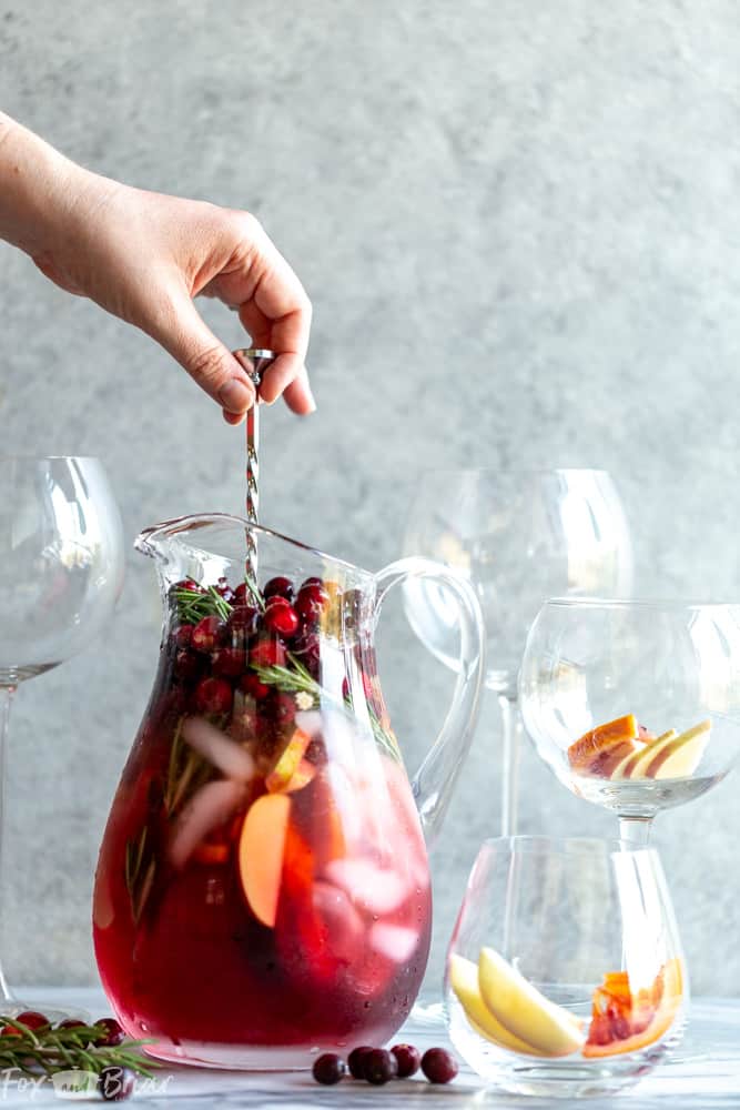 This Cranberry Orange Sangria Recipe is the perfect cocktail for Thanksgiving or Christmas parties!  Easy to mix together, and you can make it ahead of time, this festive sangria will be a hit! |Easy Sangria Recipe | White Sangria | Thanksgiving Sangria | Christmas Sangria | Sangria for a crowd | Thanksgiving cocktail | Christmas party | Winter Sangria | Holiday Sangria