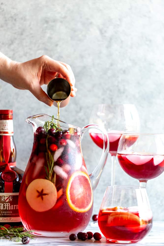 This Cranberry Orange Sangria Recipe is the perfect cocktail for Thanksgiving or Christmas parties!  Easy to mix together, and you can make it ahead of time, this festive sangria will be a hit! |Easy Sangria Recipe | White Sangria | Thanksgiving Sangria | Christmas Sangria | Sangria for a crowd | Thanksgiving cocktail | Christmas party | Winter Sangria | Holiday Sangria