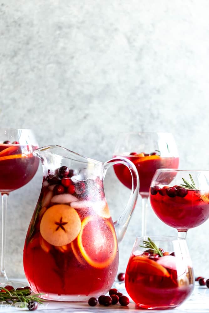 This Cranberry Orange Sangria Recipe is the perfect cocktail for Thanksgiving or Christmas parties!  Easy to mix together, and you can make it ahead of time, this festive sangria will be a hit! |Easy Sangria Recipe | White Sangria | Thanksgiving Sangria | Christmas Sangria | Sangria for a crowd | Thanksgiving cocktail | Christmas party | Winter Sangria | Holiday Sangria