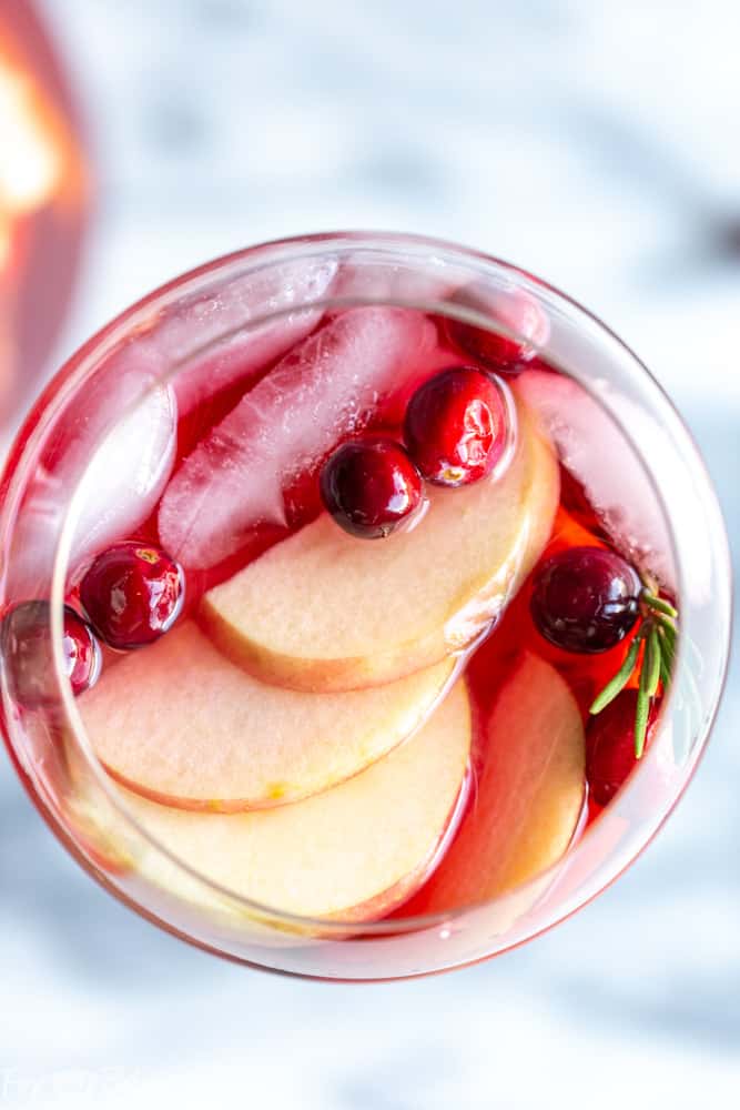 This Cranberry Orange Sangria Recipe is the perfect cocktail for Thanksgiving or Christmas parties!  Easy to mix together, and you can make it ahead of time, this festive sangria will be a hit! |Easy Sangria Recipe | White Sangria | Thanksgiving Sangria | Christmas Sangria | Sangria for a crowd | Thanksgiving cocktail | Christmas party | Winter Sangria | Holiday Sangria