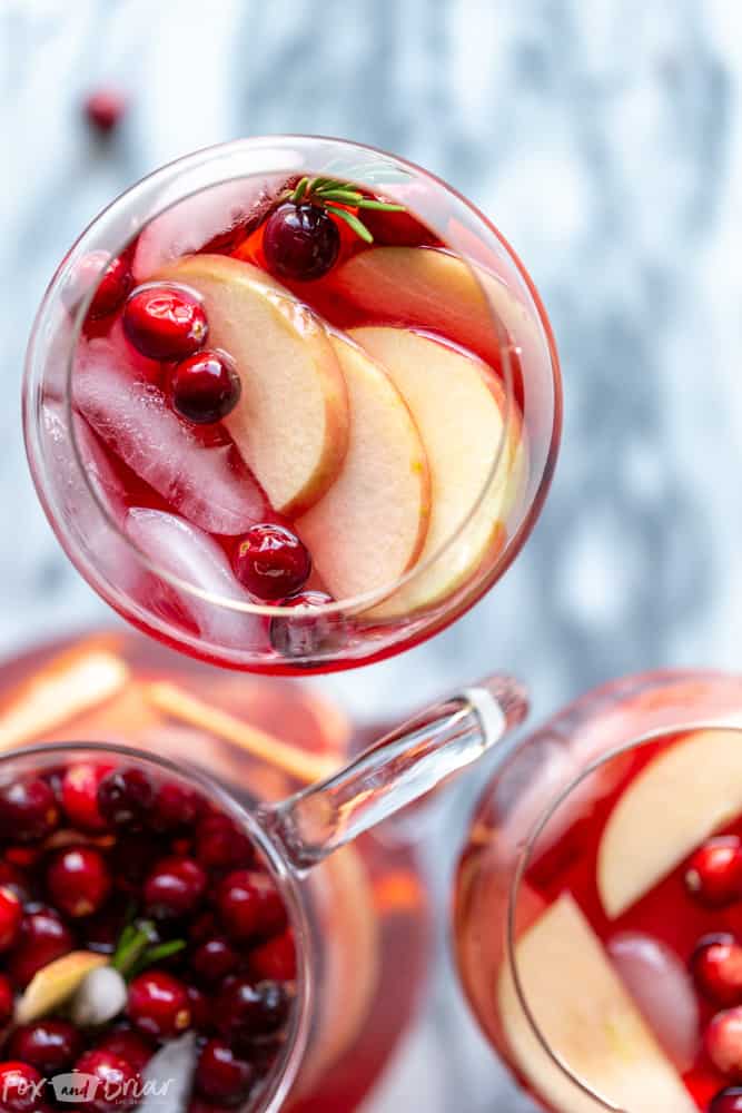 This Cranberry Orange Sangria Recipe is the perfect cocktail for Thanksgiving or Christmas parties! Easy to mix together, and you can make it ahead of time, this festive sangria will be a hit! |Easy Sangria Recipe | White Sangria | Thanksgiving Sangria | Christmas Sangria | Sangria for a crowd | Thanksgiving cocktail | Christmas party | Winter Sangria | Holiday Sangria