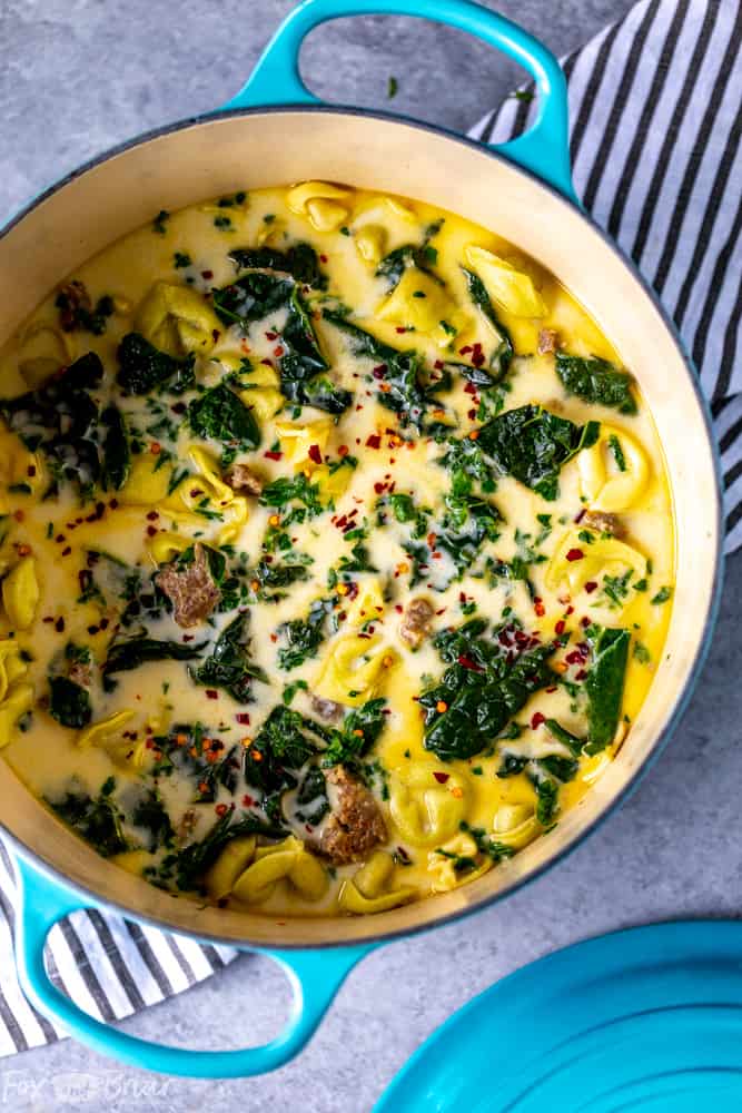 This Creamy Sausage and Tortellini Soup only has five ingredients and is ready in 30 minutes! Make this easy and delicious soup for dinner tonight! | Sausage and Kale Soup | Zuppa Toscana | Creamy sausage soup | Sausage and tortellini soup | with kale