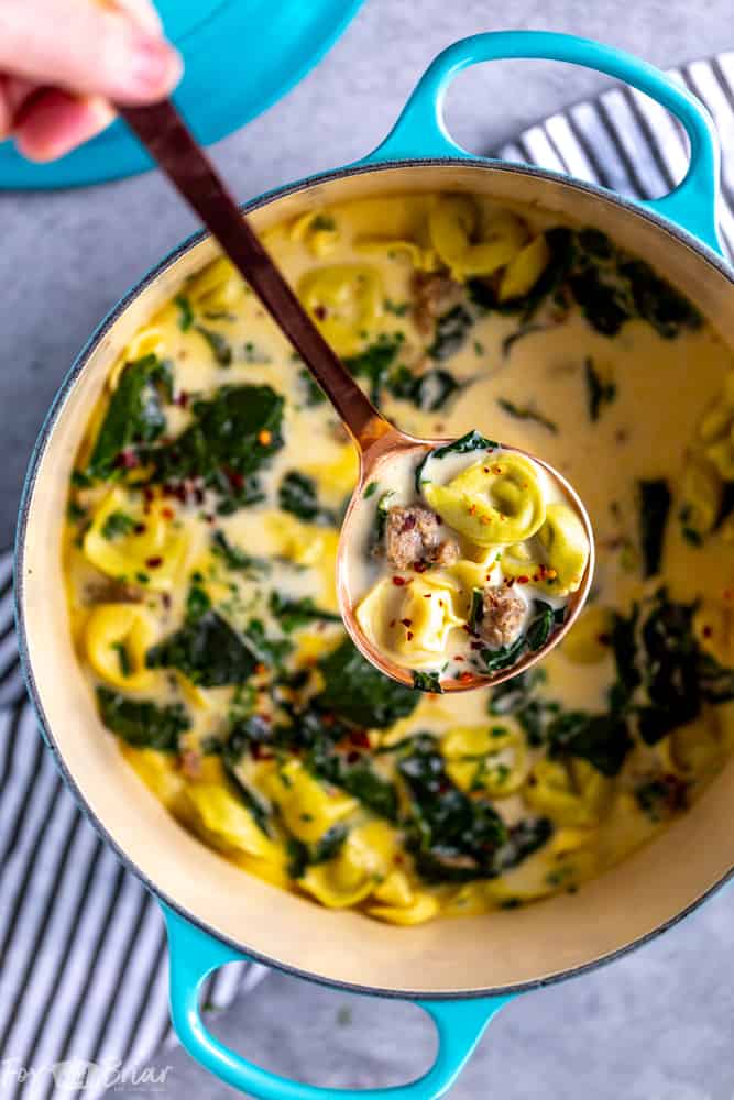 This Creamy Sausage and Tortellini Soup only has five ingredients and is ready in 30 minutes! Make this easy and delicious soup for dinner tonight! | Sausage and Kale Soup | Zuppa Toscana | Creamy sausage soup | Sausage and tortellini soup | with kale