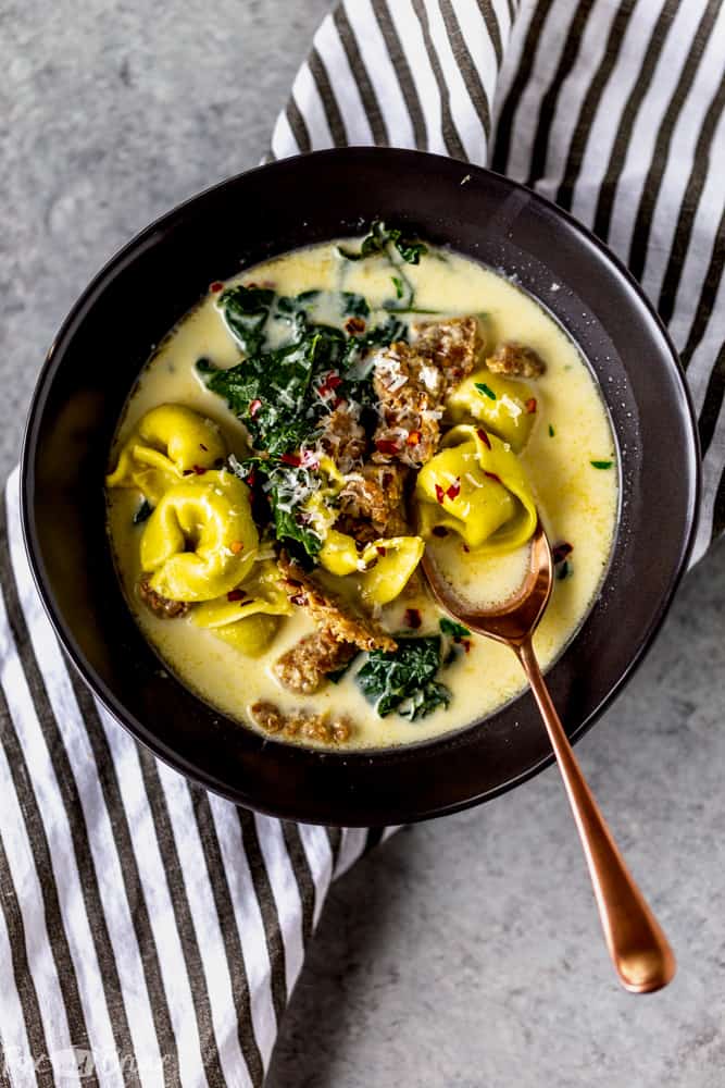 This Creamy Sausage and Tortellini Soup only has five ingredients and is ready in 30 minutes! Make this easy and delicious soup for dinner tonight! | Sausage and Kale Soup | Zuppa Toscana | Creamy sausage soup | Sausage and tortellini soup | with kale