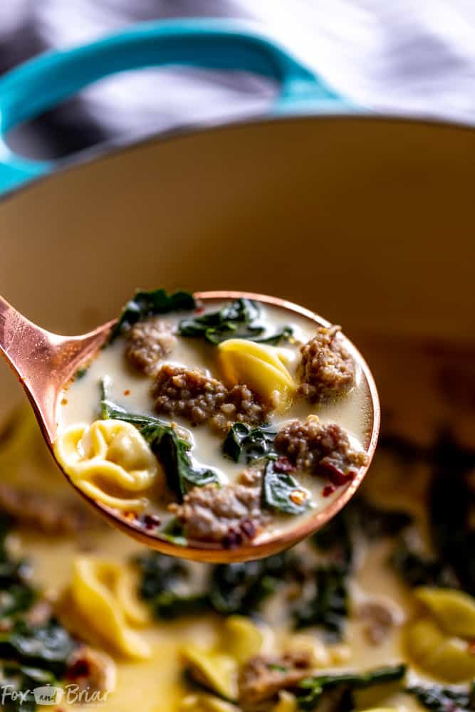 This Creamy Sausage and Tortellini Soup only has five ingredients and is ready in 30 minutes! Make this easy and delicious soup for dinner tonight! | Sausage and Kale Soup | Zuppa Toscana | Creamy sausage soup | Sausage and tortellini soup | with kale