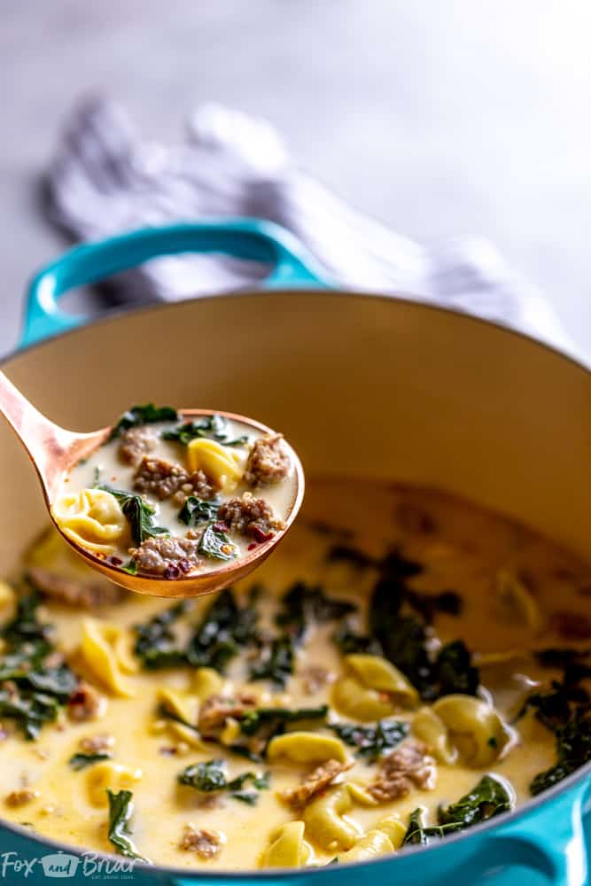 This Creamy Sausage and Tortellini Soup only has five ingredients and is ready in 30 minutes! Make this easy and delicious soup for dinner tonight! | Sausage and Kale Soup | Zuppa Toscana | Creamy sausage soup | Sausage and tortellini soup | with kale