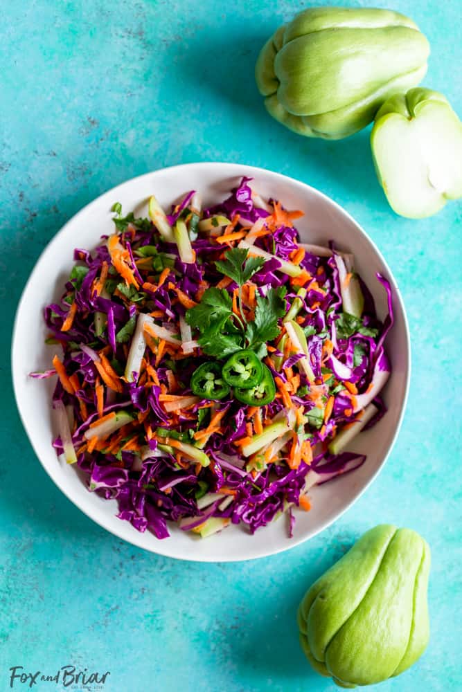 Chayote Recipe - Cilantro Lime Chayote Slaw is crunchy and vibrant.  Using chayote squash, cabbage, carrots and jalapeno this slaw is perfect for tacos. It also makes a great light and healthy side dish for any dinner! Healthy recipe | Taco Slaw | Cabbage recipe | Low fat | Low Carb | Low Calorie | health benefits of chayote | What is chayote | How to cook chayote | Chayote recipes | Mexican Recipes | What to serve with tacos