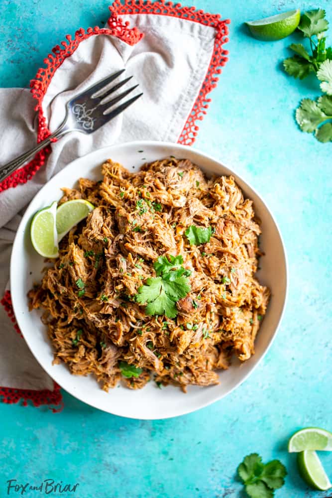 This delicious Slow Cooker Carnitas recipe is tender and juicy, yet simple to make.  Mexican pulled pork is great to have on hand for carnitas tacos, burrito bowls, salads, sandwiches and more. | Easy pork carnitas | Crock Pot Carnitas | Chipotle copycat | Crispy carnitas | Keto Carnitas