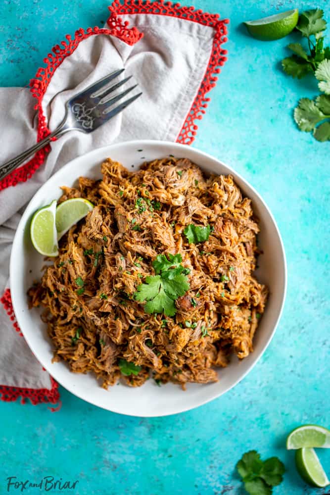 This delicious Slow Cooker Carnitas recipe is tender and juicy, yet simple to make.  Mexican pulled pork is great to have on hand for carnitas tacos, burrito bowls, salads, sandwiches and more. | Easy pork carnitas | Crock Pot Carnitas | Chipotle copycat | Crispy carnitas | Keto Carnitas