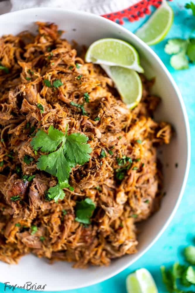 This delicious Slow Cooker Carnitas recipe is tender and juicy, yet simple to make.  Mexican pulled pork is great to have on hand for carnitas tacos, burrito bowls, salads, sandwiches and more. | Easy pork carnitas | Crock Pot Carnitas | Chipotle copycat | Crispy carnitas | Keto Carnitas