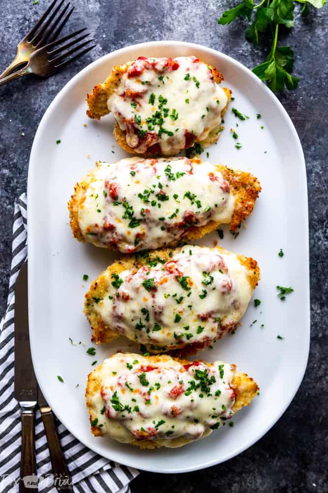 This delicious Oven Baked Chicken Parmesan recipe is easy and doesn't require any frying.  Because this chicken Parmesan is baked, it is healthy, quick and easy! Make this crispy baked Parmesan crusted chicken for dinner tonight in about thirty minutes! Easy dinner recipe | Chicken recipe | Dinner recipe | Chicken breast recipe | Italian recipe | Olive garden copycat | Healthy panko crusted chicken | Parmesan crusted chicken