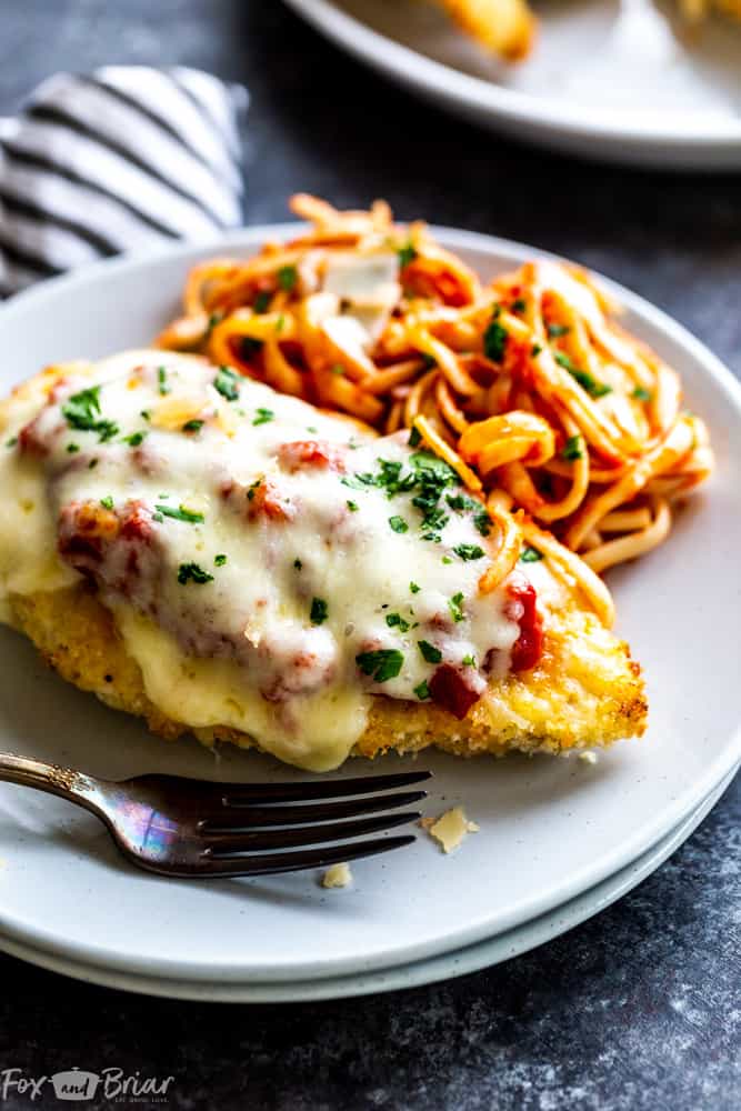 This delicious Oven Baked Chicken Parmesan recipe is easy and doesn't require any frying.  Because this chicken Parmesan is baked, it is healthy, quick and easy! Make this crispy baked Parmesan crusted chicken for dinner tonight in about thirty minutes! Easy dinner recipe | Chicken recipe | Dinner recipe | Chicken breast recipe | Italian recipe | Olive garden copycat | Healthy panko crusted chicken | Parmesan crusted chicken