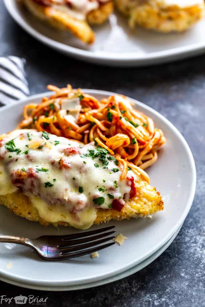 This delicious Oven Baked Chicken Parmesan recipe is easy and doesn't require any frying.  Because this chicken Parmesan is baked, it is healthy, quick and easy! Make this crispy baked Parmesan crusted chicken for dinner tonight in about thirty minutes! Easy dinner recipe | Chicken recipe | Dinner recipe | Chicken breast recipe | Italian recipe | Olive garden copycat | Healthy panko crusted chicken | Parmesan crusted chicken