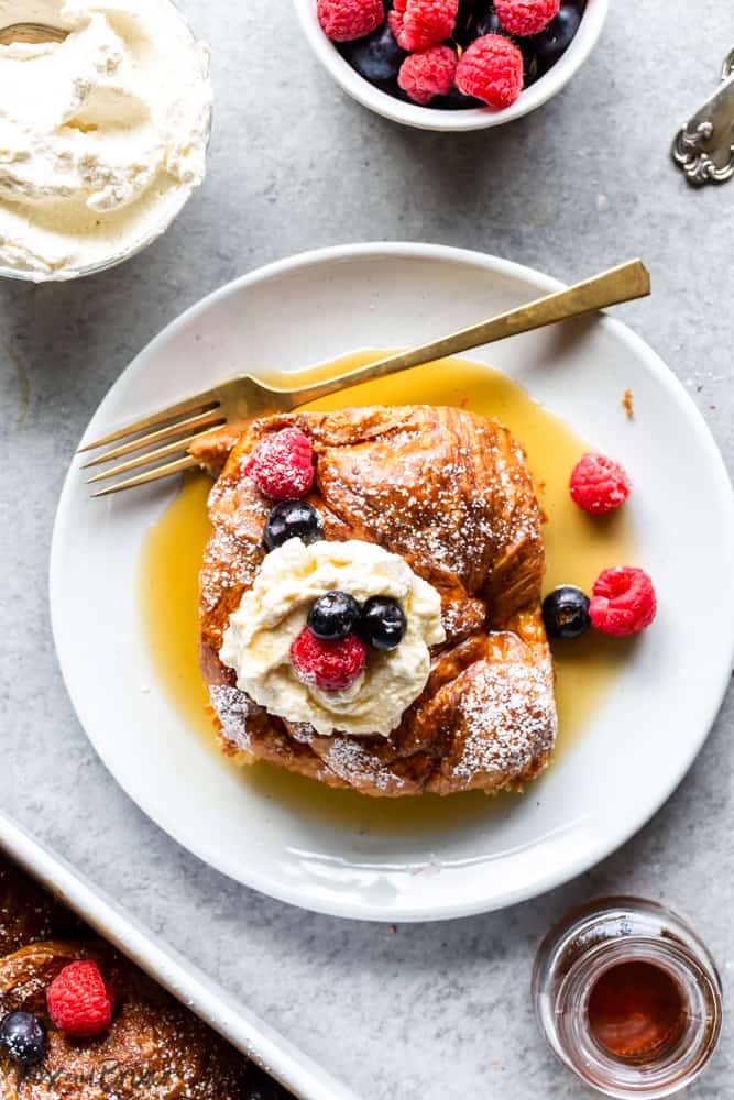 One serving of Croissant french toast with whipped cream and berries