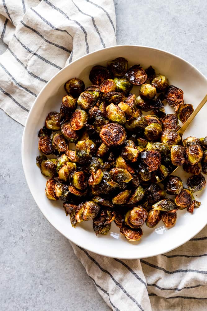 These Easy Roasted Brussels Sprouts have only four ingredients and are so simple to make!  Brussels Sprouts make a great side dish for a weeknight dinner or even a special holiday meal like Thanksgiving or Christmas! | oven baked brussels sprouts | easy brussels sprouts | side dish recipes | Christmas dinner ideas | thanksgiving recipes | thanksgiving side dishes | easy side dishes | brussels sprouts recipes