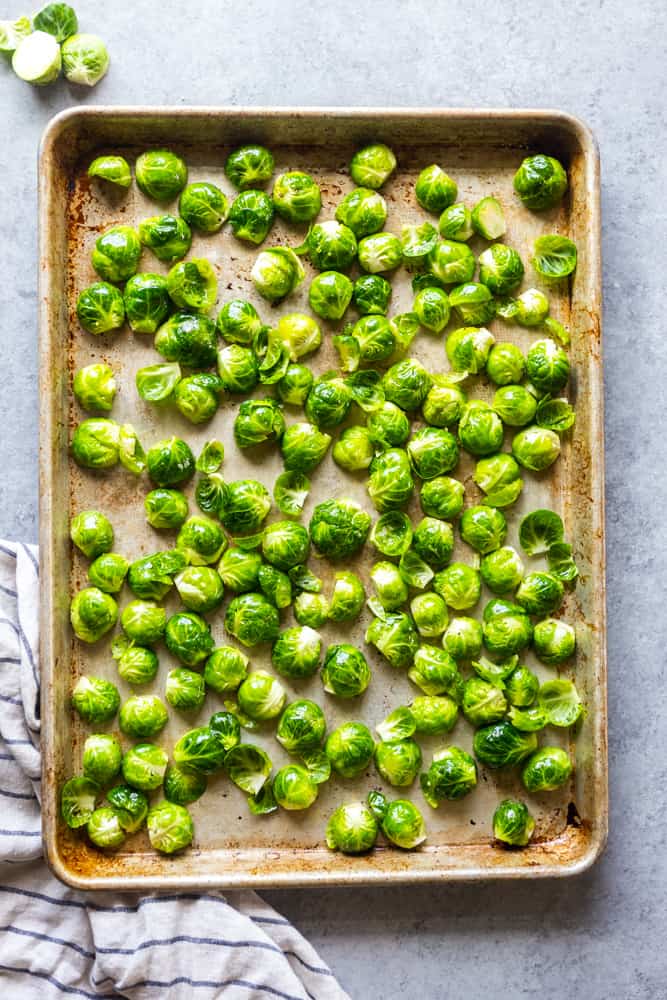 These Easy Roasted Brussels Sprouts have only four ingredients and are so simple to make!  Brussels Sprouts make a great side dish for a weeknight dinner or even a special holiday meal like Thanksgiving or Christmas! | oven baked brussels sprouts | easy brussels sprouts | side dish recipes | Christmas dinner ideas | thanksgiving recipes | thanksgiving side dishes | easy side dishes | brussels sprouts recipes