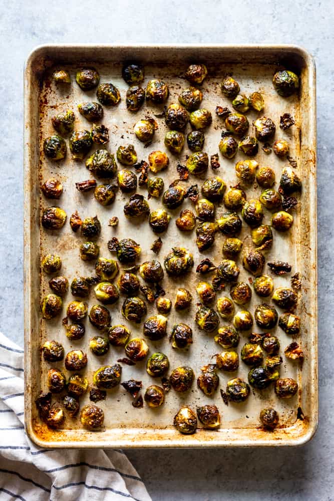 These Easy Roasted Brussels Sprouts have only four ingredients and are so simple to make!  Brussels Sprouts make a great side dish for a weeknight dinner or even a special holiday meal like Thanksgiving or Christmas! | oven baked brussels sprouts | easy brussels sprouts | side dish recipes | Christmas dinner ideas | thanksgiving recipes | thanksgiving side dishes | easy side dishes | brussels sprouts recipes