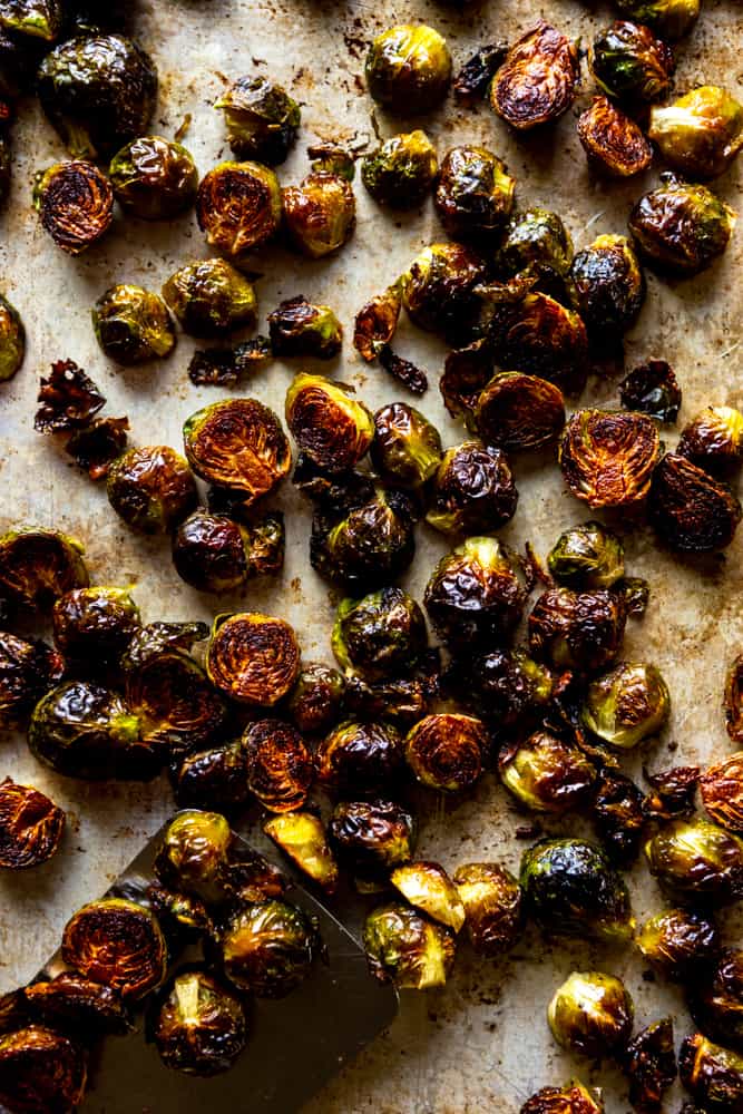 These Easy Roasted Brussels Sprouts have only four ingredients and are so simple to make!  Brussels Sprouts make a great side dish for a weeknight dinner or even a special holiday meal like Thanksgiving or Christmas! | oven baked brussels sprouts | easy brussels sprouts | side dish recipes | Christmas dinner ideas | thanksgiving recipes | thanksgiving side dishes | easy side dishes | brussels sprouts recipes