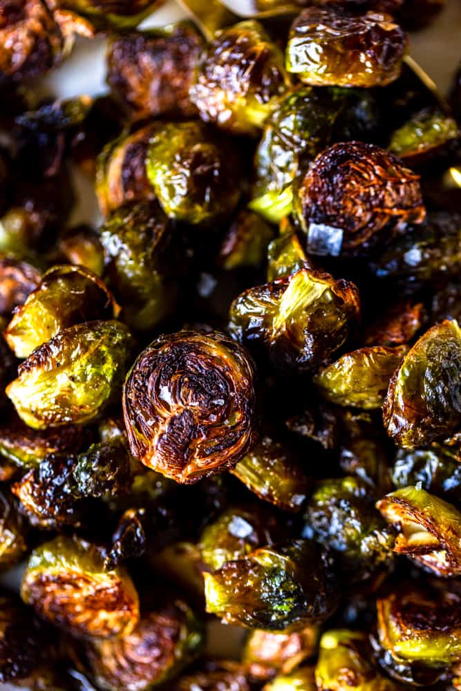 These Easy Roasted Brussels Sprouts have only four ingredients and are so simple to make!  Brussels Sprouts make a great side dish for a weeknight dinner or even a special holiday meal like Thanksgiving or Christmas! | oven baked brussels sprouts | easy brussels sprouts | side dish recipes | Christmas dinner ideas | thanksgiving recipes | thanksgiving side dishes | easy side dishes | brussels sprouts recipes