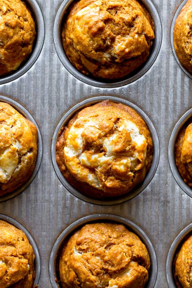 Baked pumpkin cream cheese muffins in muffin tin