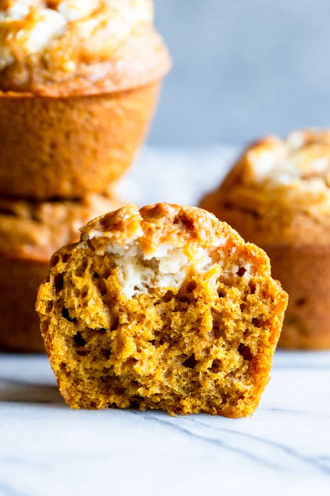 Cross section of pumpkin cream cheese muffin cut in half