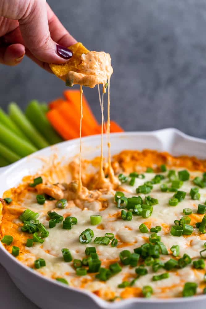 Chip dipping into buffalo chicken dip