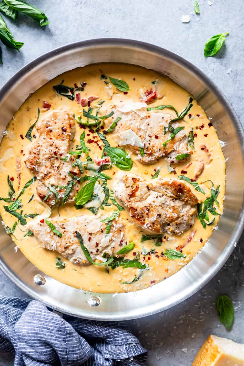 skillet with a creamy sauce and seared pork chops