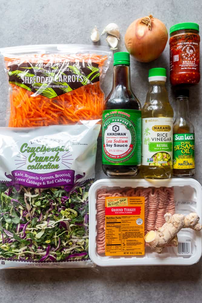 ingredients for eggroll in a bowl - carrots, onion, garlic, chicli garlic sauce, cruciferous crunch, low sodium soy sauce, rice vinegar, sesame oil, ground turkey, ginger