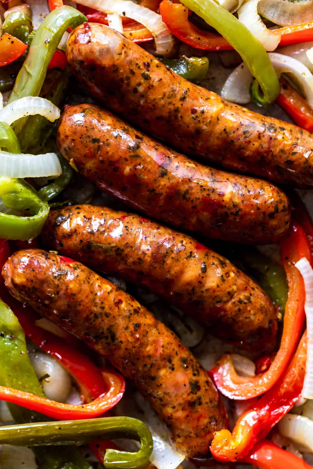 Cooked sausages with bell peppers and onions