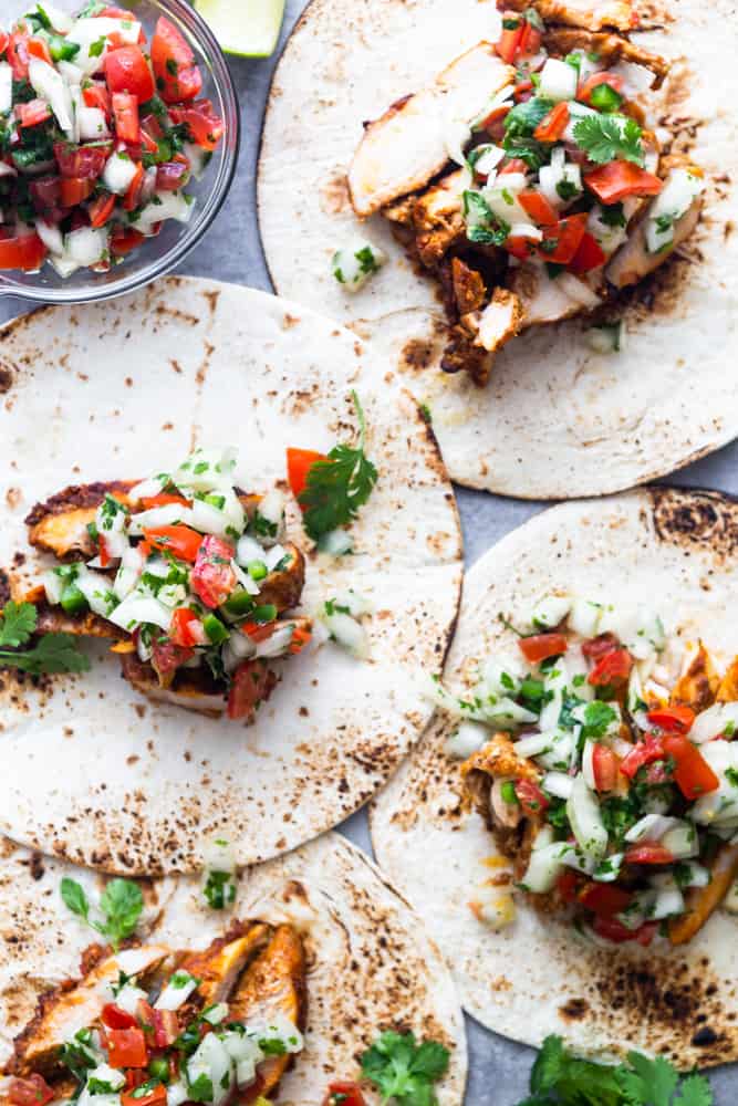 tortillas piled high with chili lime chicken and pico de gallo