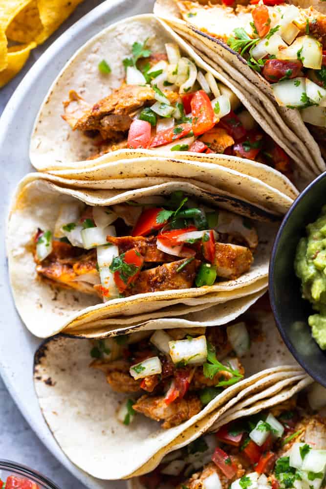 chili lime chicken tacos on a plate with pico de gallo