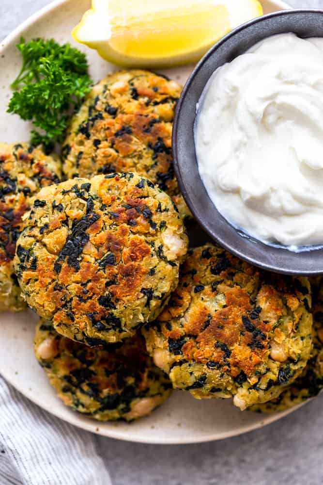 white bean and kale patties on a white plate