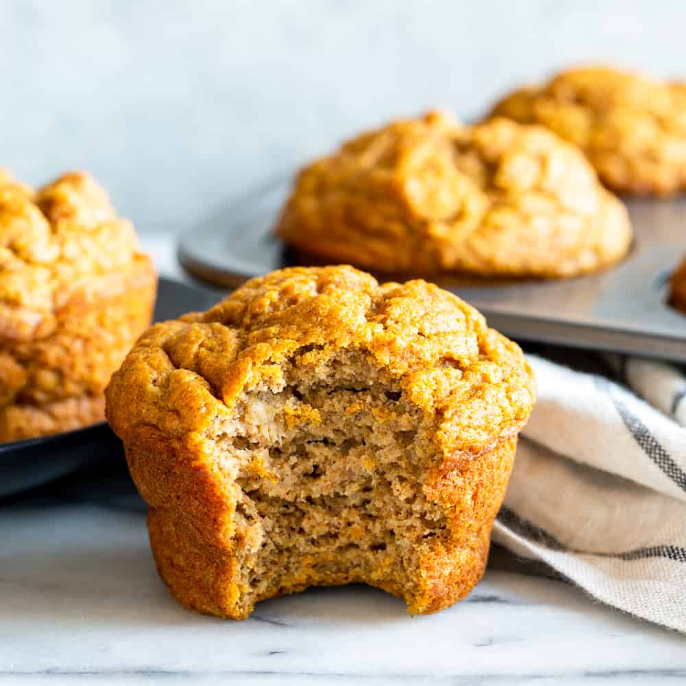 close up of pumpkin banana muffin with a bite taken out of it.