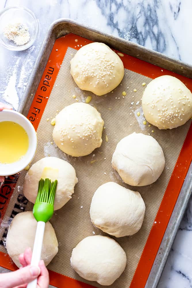 Brushing an egg wash on to unbaked burger buns