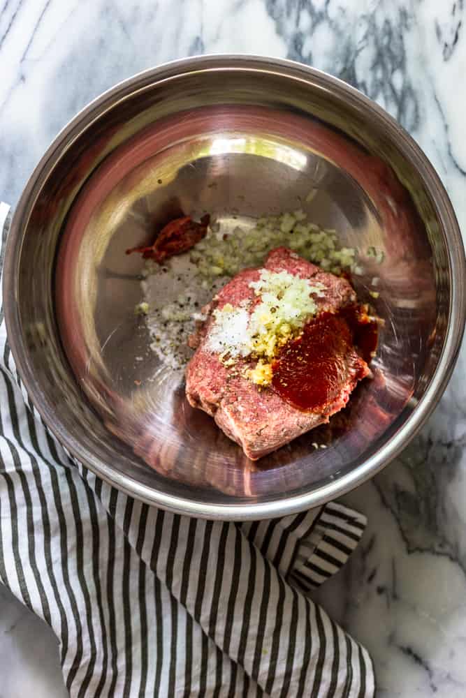 Ingredients for BBQ burgers in a steel bowl