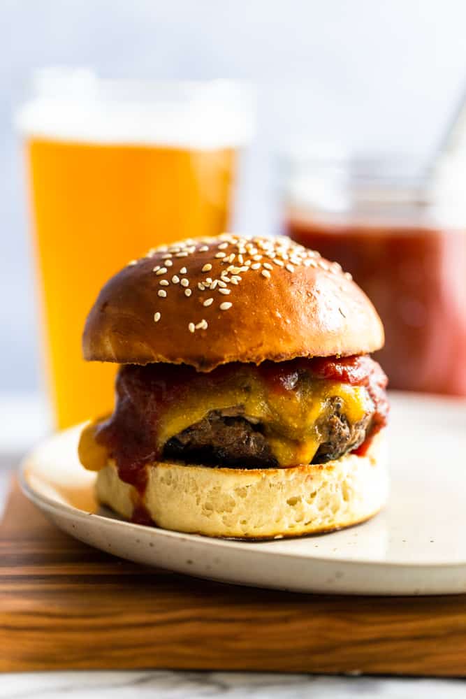 Cheeseburger with bbq sauce on a white plate