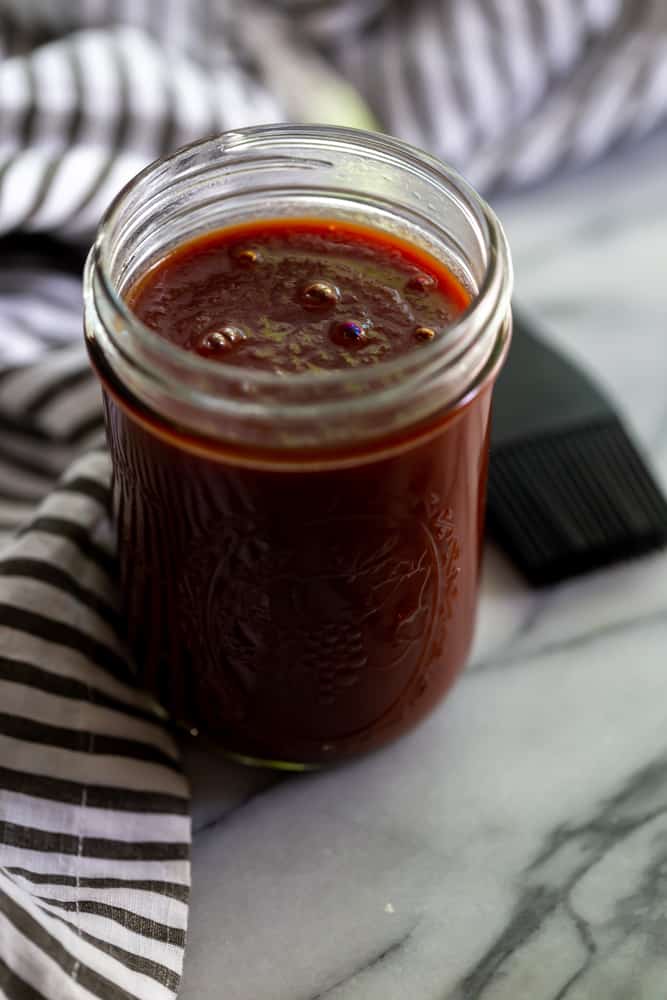 Mason Jar of BBQ Sauce on a marble surface