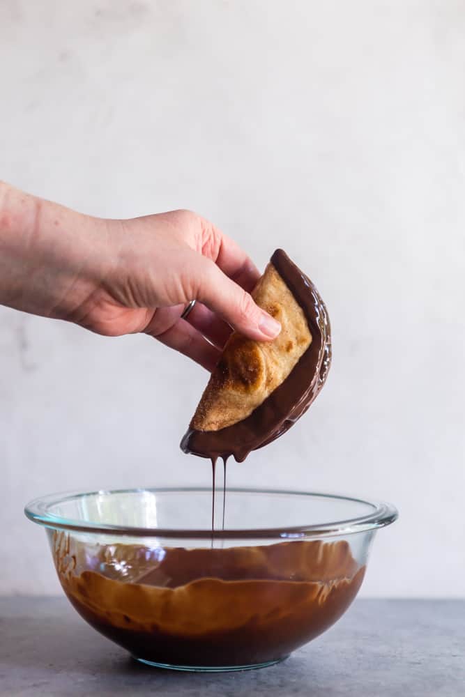 Chocolate dripping off of an ice cream taco.