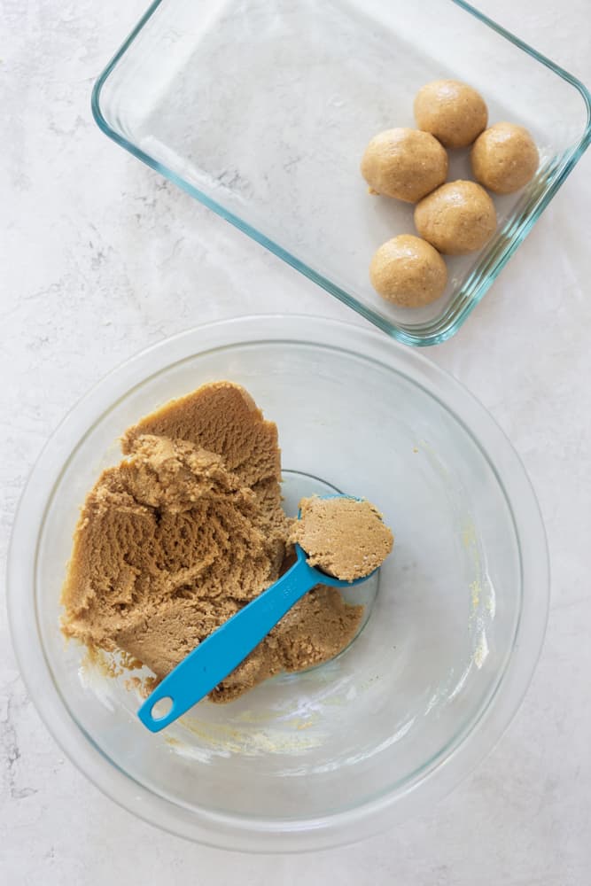 Peanut butter energy balls dough in a bowl with a tablespoon