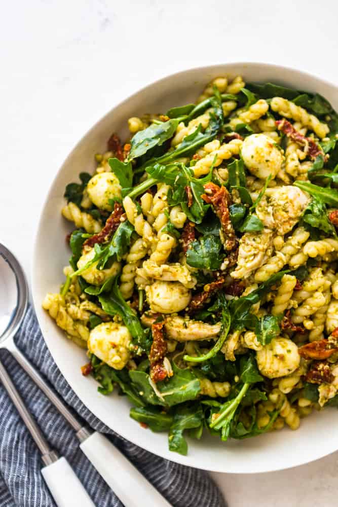 Chicken pesto pasta salad in a white bowl