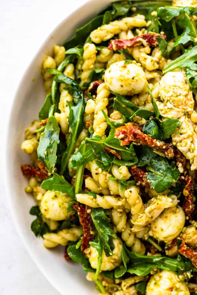 Closeup of Chicken Pesto Pasta Salad in a white bowl