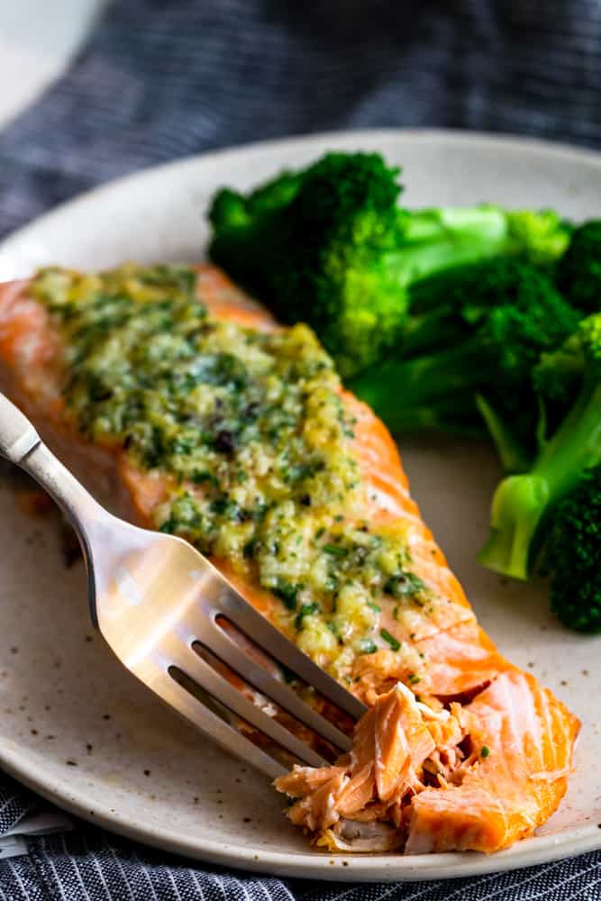 Fork digging into flaky salmon